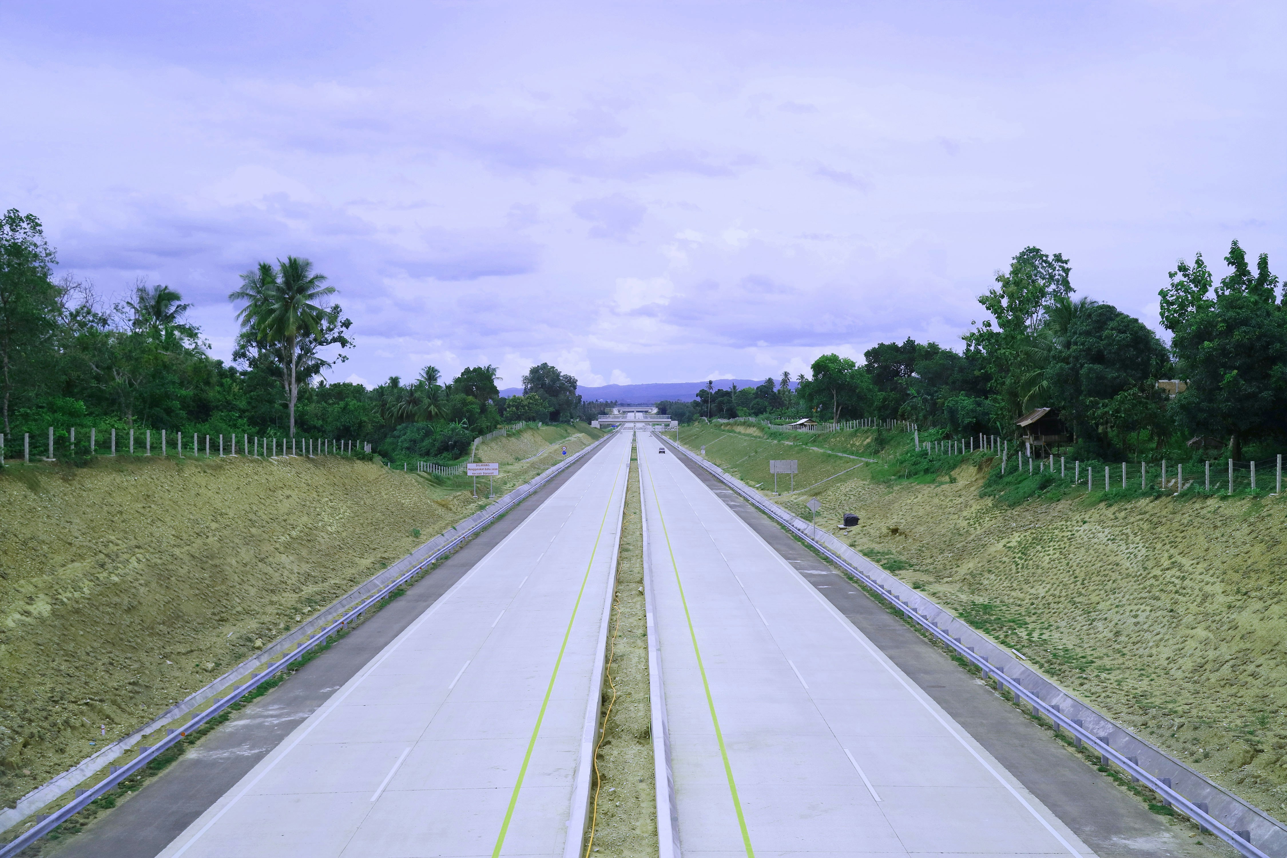 a long stretch of road with a sky background